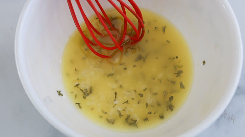 melted butter and herbs in bowl