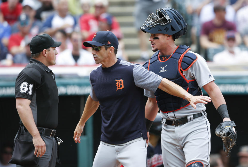 Home plate umpire Quinn Wolcott argues with Tigers manager Brad Ausmus and catcher James McCann moments before being hit by a questionable pitch. (AP)