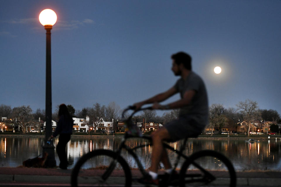 Cyclists and pedestrians pass by Smith Lake in Washington Park on April 7, 2020, in Denver. The city is closing some streets to cars in response to the coronavirus. (Photo: Helen H. Richardson/MediaNews Group/The Denver Post via Getty Images via Getty Images)