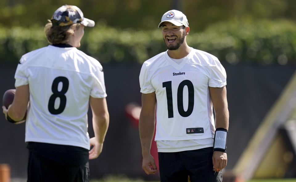 Pittsburgh Steelers quarterback Mitch Trubisky, right, talks with Kenny Pickett during NFL football practice, Tuesday, Sept. 20, 2022, at UPMC Rooney Sports Complex in Pittsburgh. (Matt Freed/Pittsburgh Post-Gazette via AP)