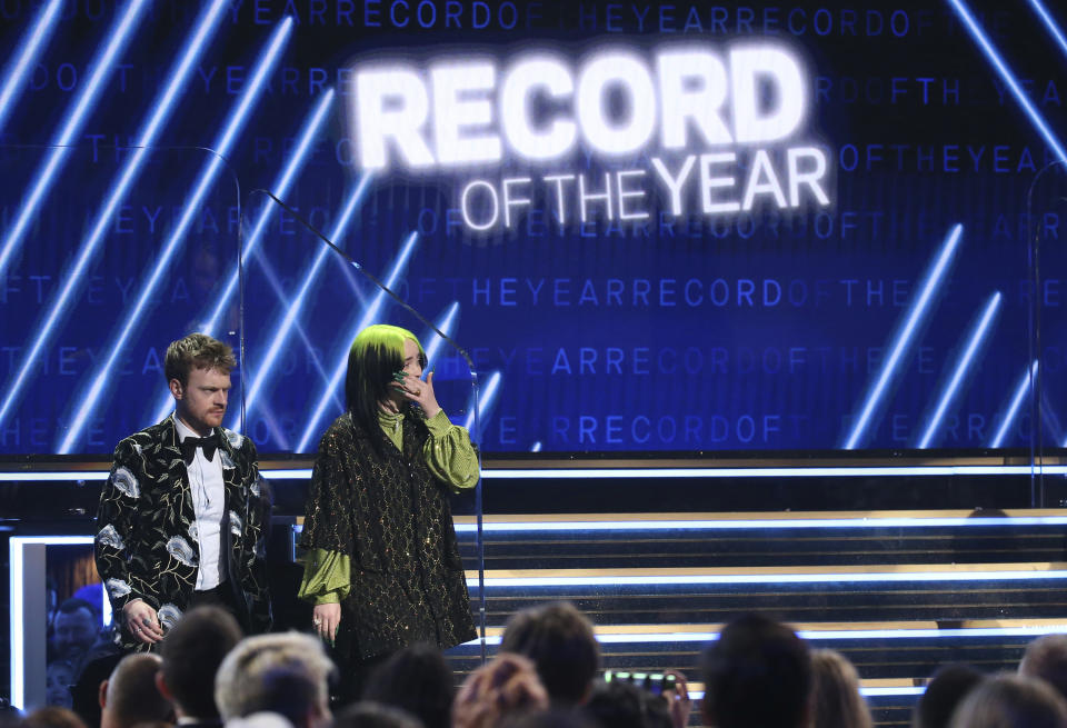 Finneas O'Connell, left, and Billie Eilish are seen in the audience before accepting the award for record of the year for "Bad Guy" at the 62nd annual Grammy Awards on Sunday, Jan. 26, 2020, in Los Angeles. (Photo by Matt Sayles/Invision/AP)