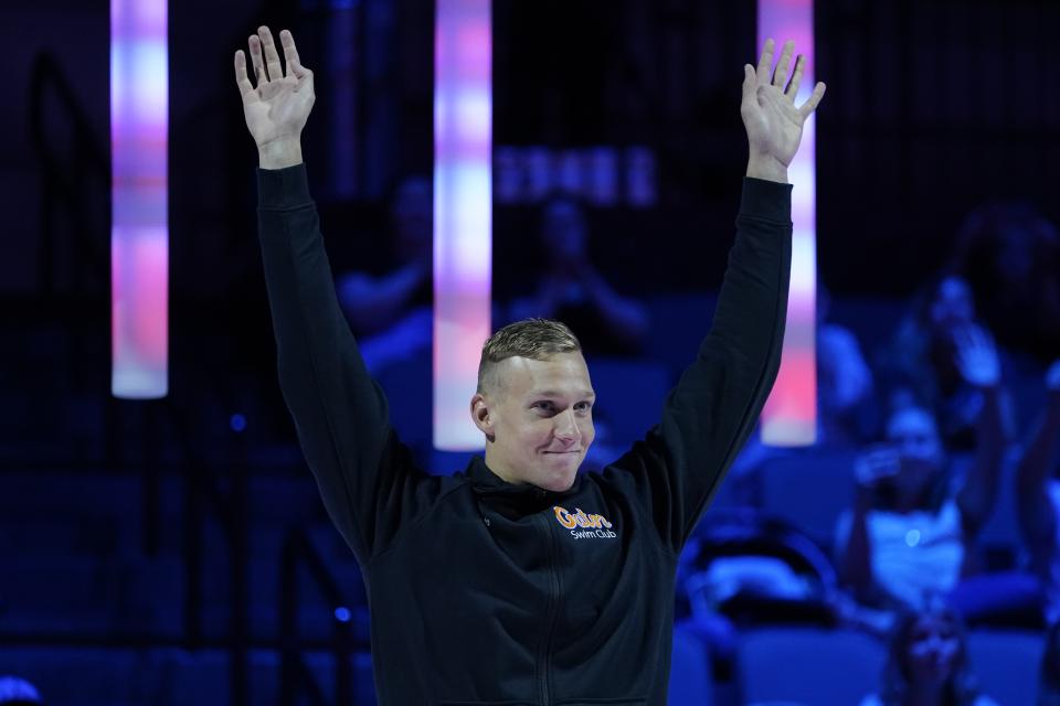 Caeleb Dressel reacts at the medal ceremony for the men's 50 freestyle during wave 2 of the U.S. Olympic Swim Trials on Sunday, June 20, 2021, in Omaha, Neb. (AP Photo/Charlie Neibergall)