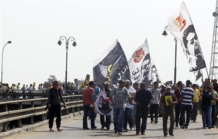 Members of the Muslim Brotherhood and supporters of ousted Egyptian president Mohamed Mursi shout slogans against the military and interior ministry on a bridge during a protest named "People Protect the Revolution" as they march towards the "Qasr al-Quba" presidential palace in Cairo, September 6, 2013. REUTERS/Amr Abdallah Dalsh