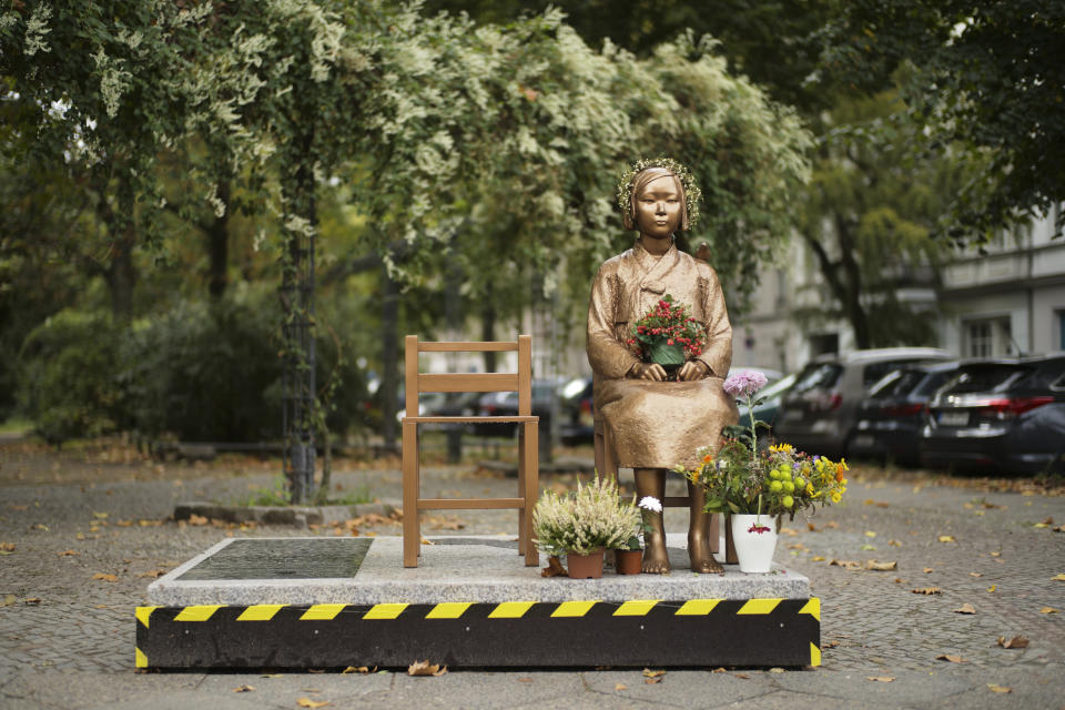 A statue commemorating so-called 'comfort women', an euphemism given by Japan to the women and girls enslaved for sex by the Japanese army during World War II, is displayed at a residential area in central Berlin, Germany, Friday, Oct. 9, 2020. (AP Photo/Markus Schreiber)