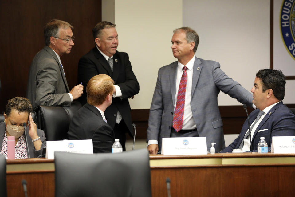 Several South Carolina House members confer during a break in a meeting of a special House committee looking at a stricter abortion law in the state on Tuesday, July 19, 2022, in Columbia, South Carolina. (AP Photo/Jeffrey Collins)