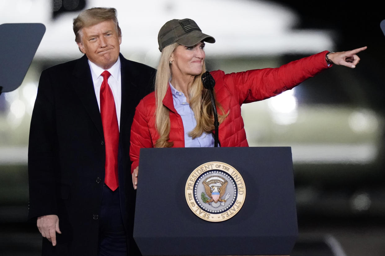 Sen. Kelly Loeffler, R-Ga., speaks as President Donald Trump listens during a campaign rally in support of Senate candidates Sen. Kelly Loeffler, R-Ga., and David Perdue in Dalton, Ga., Monday, Jan. 4, 2021. (AP Photo/Brynn Anderson)