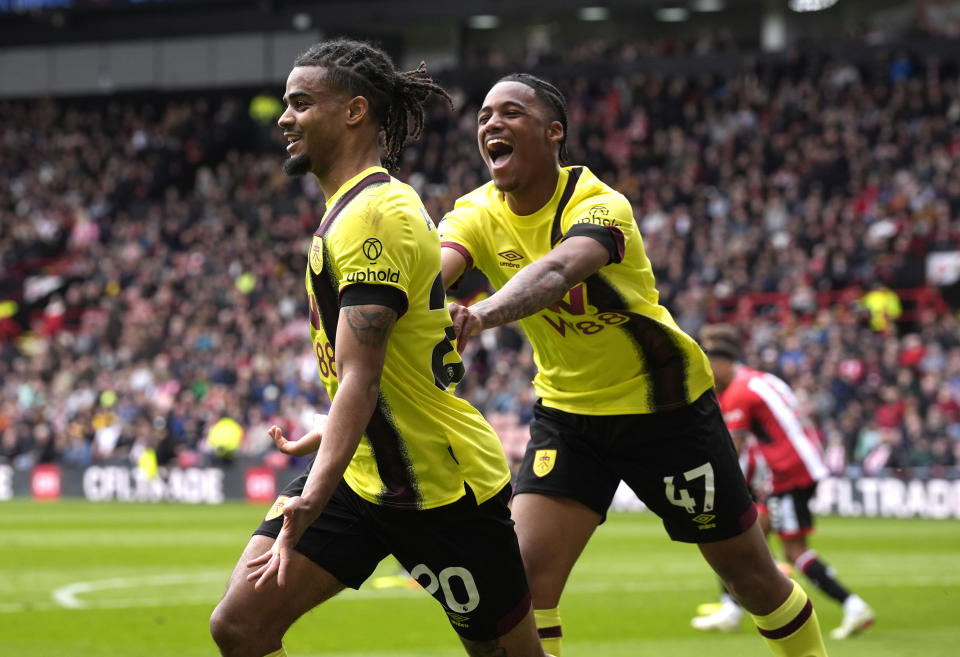 Burnley's Lorenz Assignon, left, celebrates scoring their side's second goal of the game during the English Premier League soccer match between Burnley FC and Sheffield United at Bramall Lane, Sheffield, England, Saturday April 20, 2024. (Danny Lawson/PA via AP)