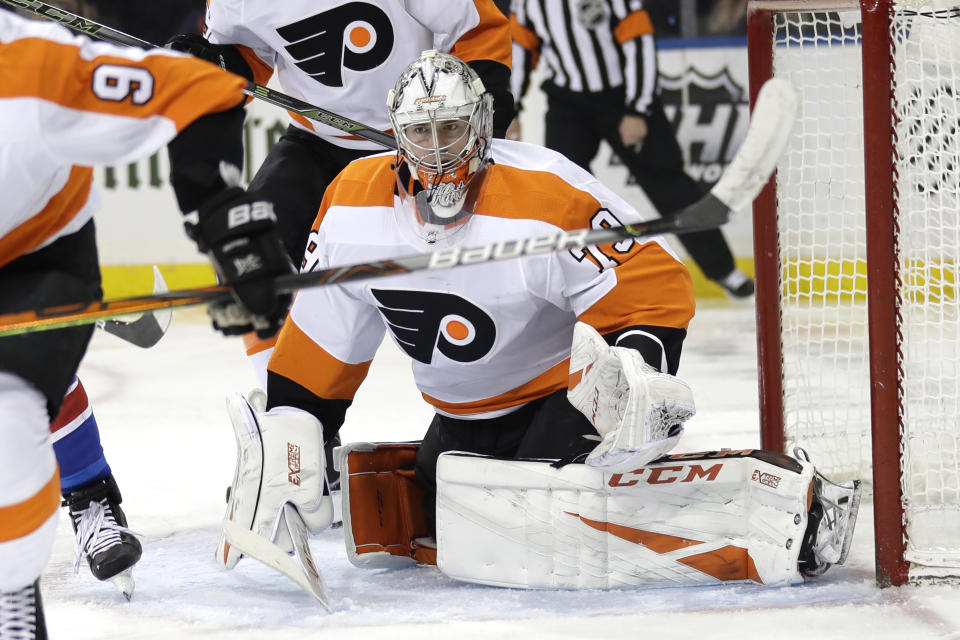 Philadelphia Flyers goaltender Carter Hart itches the puck during the second period of the NHL hockey game against the New York Rangers, Sunday, March 1, 2020, in New York. (AP Photo/Seth Wenig)