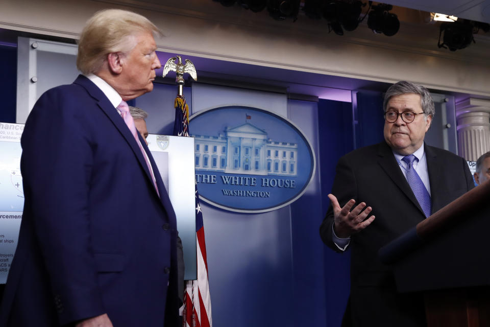 President Donald Trump listens as Attorney General William Barr speaks about the coronavirus in the James Brady Press Briefing Room of the White House, Wednesday, April 1, 2020, in Washington. (AP Photo/Alex Brandon)