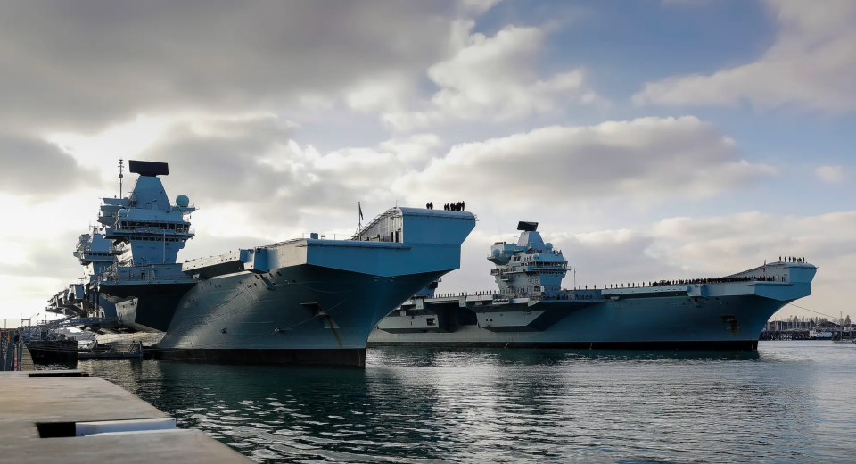 HMS <em>Prince of Wales</em>, left, alongside sister vessel HMS <em>Queen Elizabeth</em>, at HMNB Portsmouth. <em>Crown Copyright</em>