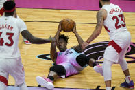 Miami Heat forward Jimmy Butler (22) looks to pass in between Toronto Raptors forward Pascal Siakam (43) and guard Fred VanVleet (23) during the second half of an NBA basketball game, Wednesday, Feb. 24, 2021, in Miami. (AP Photo/Lynne Sladky)