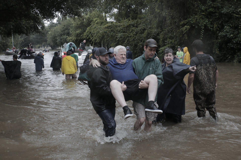 Police and volunteers rescue residents flooded by the San Jacinto river in Kingwood, Texas.&nbsp;