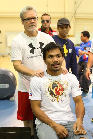 Freddie Roach poses for a photo with Manny Pacquiao before a training session. (Getty)