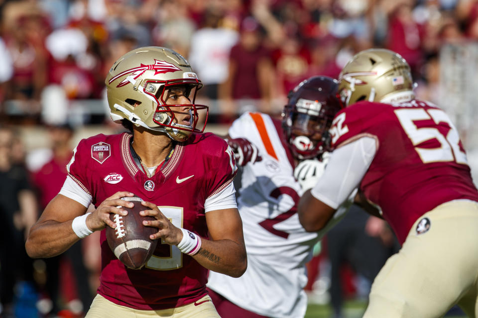 Florida State quarterback Jordan Travis (13) looks for a receiver during the first half of an NCAA college football game, Saturday, Oct. 7, 2023, in Tallahassee, Fla. (AP Photo/Colin Hackley)