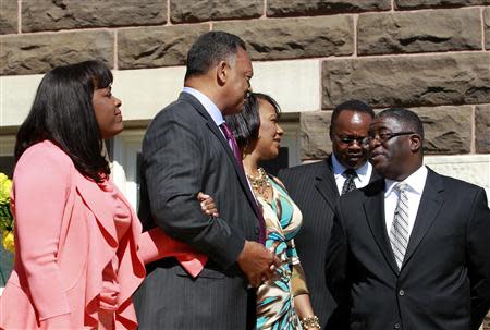 (L-R) U.S. Representative Terri Sewell, civil rights activist Reverend Jesse Jackson and Baptist minister Bernice King exit the church to go to the bell ringing and laying of the wreath at 10:22 at 16th Street Baptist Church in Birmingham, Alabama September 15, 2013. REUTERS/Marvin Gentry