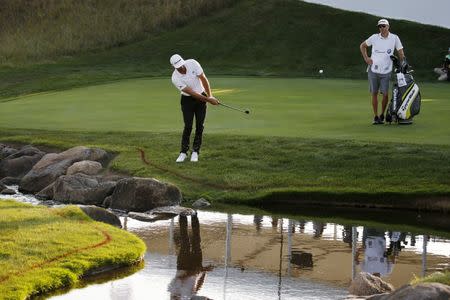 FILE PHOTO - Sep 15, 2017; Lake Forest, IL, USA; PGA golfer Dustin Johnson chips on the 18th hole during the second round of the BMW Championship golf tournament at Conway Farms Golf Club. Mandatory Credit: Brian Spurlock-USA TODAY Sports