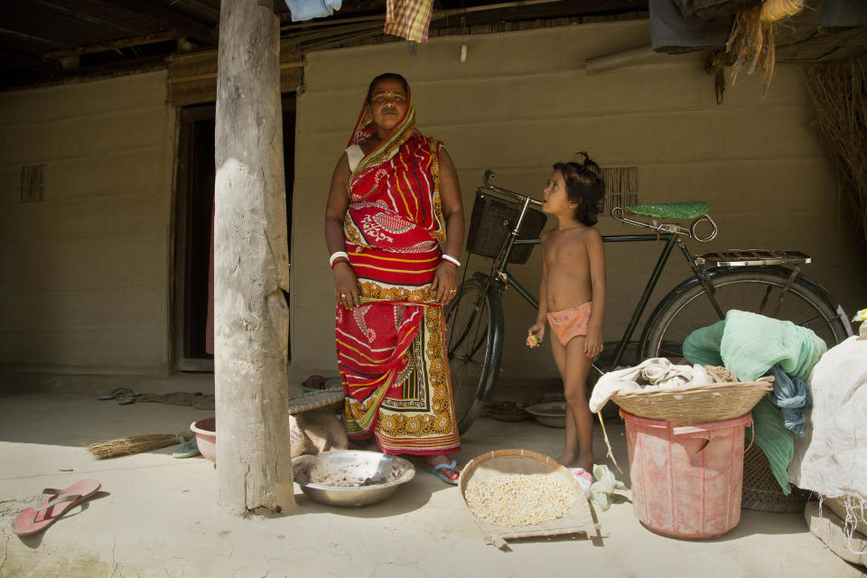 In this Thursday, Aug. 9, 2018 photo, Ekadashi Biswas, 50, who says her name does not appear on the National Register of Citizens list, stands outside her house in Mayong, 45 kilometers (28 miles) east of Gauhati, India. A draft list of citizens in Assam, released in July, put nearly 4 million people on edge to prove their Indian nationality. Nativist anger churns through Assam, just across the border from Bangladesh, with many believing the state is overrun with illegal migrants. (AP Photo/Anupam Nath)