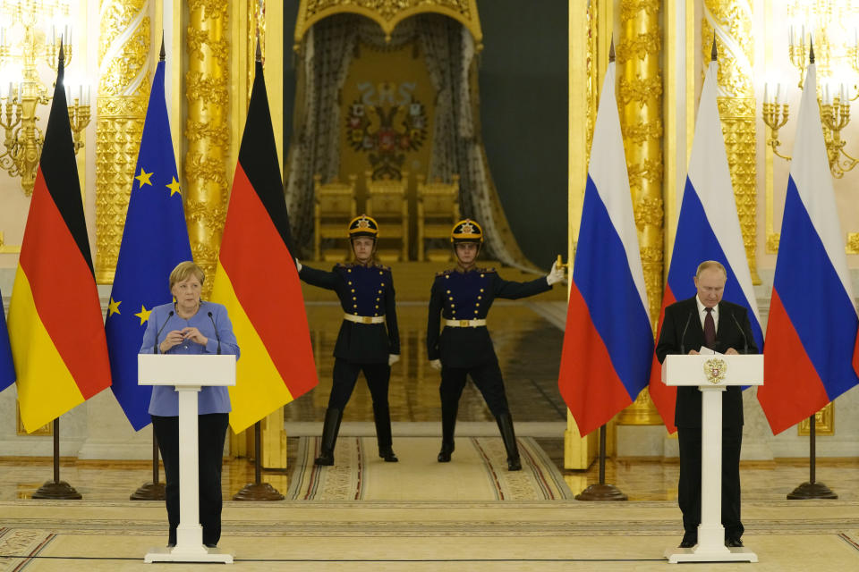 Russian President Vladimir Putin, right, and German Chancellor Angela Merkel attend a joint news conference following their talks in the Kremlin in Moscow, Russia, Friday, Aug. 20, 2021. The talks between Merkel and Putin are expected to focus on Afghanistan, the Ukrainian crisis and the situation in Belarus among other issues. (AP Photo/Alexander Zemlianichenko, Pool)