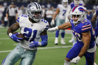 Dallas Cowboys running back Ezekiel Elliott (21) runs the ball as Buffalo Bills linebacker Matt Milano (58) gives chase in the second half of an NFL football game in Arlington, Texas, Thursday, Nov. 28, 2019. (AP Photo/Michael Ainsworth)