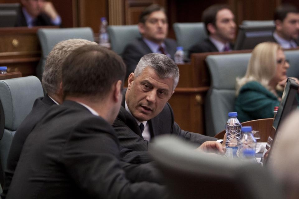 Kosovo Prime Minister Hashim Thaci, centre, speaks with deputy prime ministers during a session in Kosovo's parliament in the capital Pristina on Wednesday April 23, 2014. Kosovo's parliament voted Wednesday on a law that will enable the creation of a special war crimes tribunal staffed by international judges and prosecutors that will try alleged crimes committed by former ethnic Albanian rebels during Kosovo's 1998-99 war for independence from Serbia. (AP Photo/Visar Kryeziu)