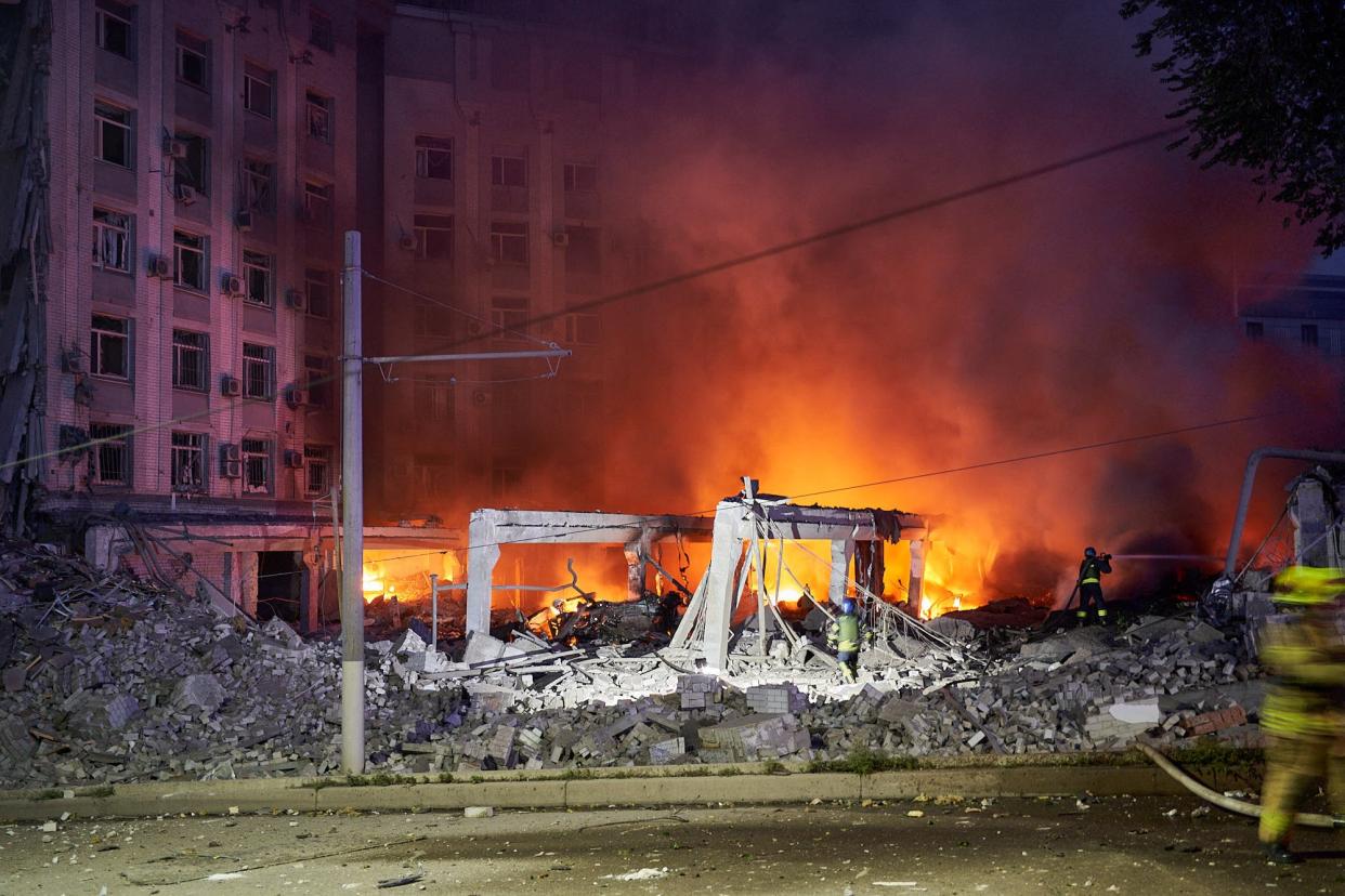 Ukrainian firefighters push out a fire in an administrative building after missiles strike in Dnipro (AFP via Getty Images)