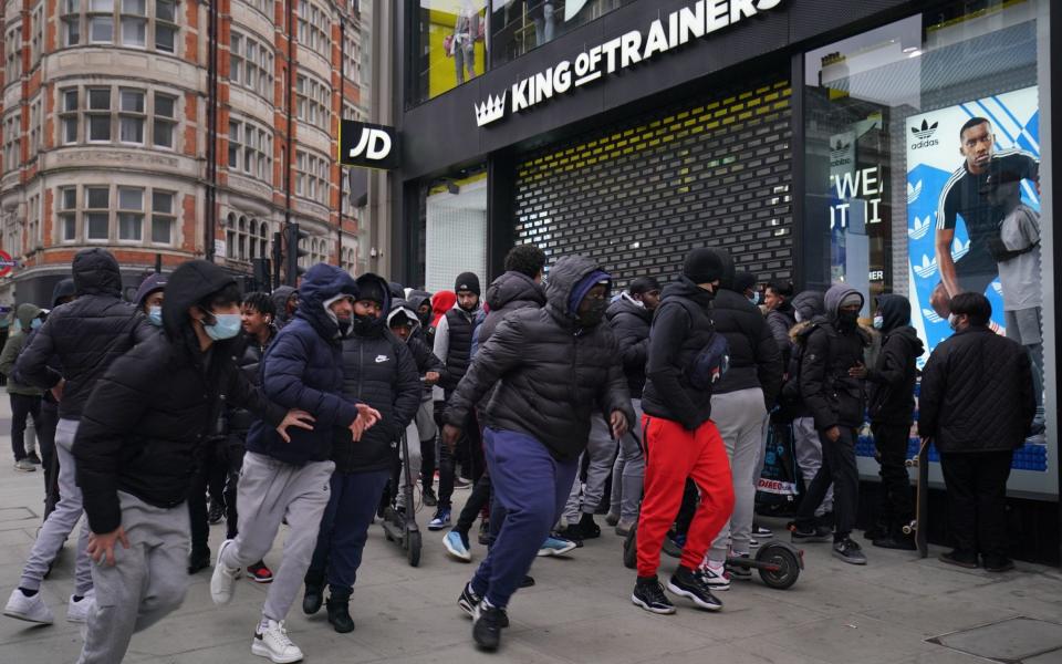 Early morning shoppers gather outside the JD Sports store in Oxford Street, London, waiting for the store to reopen as England takes another step back towards normality with the further easing of lockdown restrictions. - Aaron Chown 