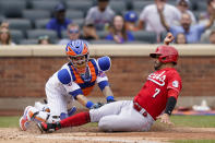 New York Mets catcher Tomas Nido, left, tags out Cincinnati Reds Eugenio Suarez (7) at home after a hit by Tyler Naquin during the fourth inning of a baseball game, Sunday, Aug. 1, 2021, in New York. (AP Photo/Corey Sipkin)