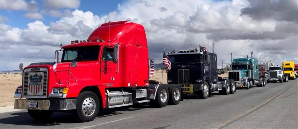 Trucks line up on Wednesday, Feb. 23 to leave Adelanto Stadium to start the cross-country People’s Convoy toward Washington, D.C.