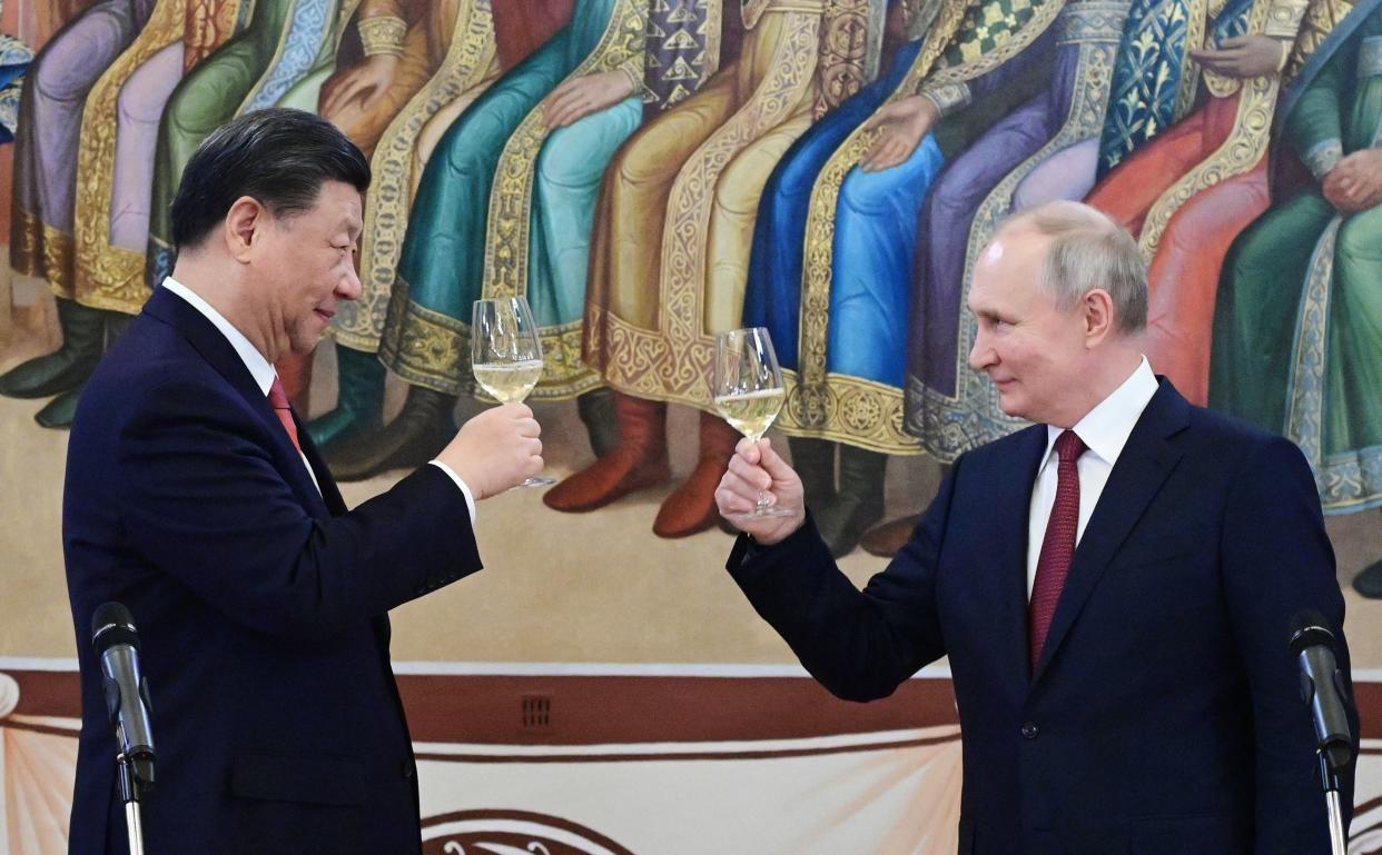 China's President Xi Jinping and Russian President Vladimir Putin make a toast during a reception following their talks at the Kremlin in Moscow in March.
