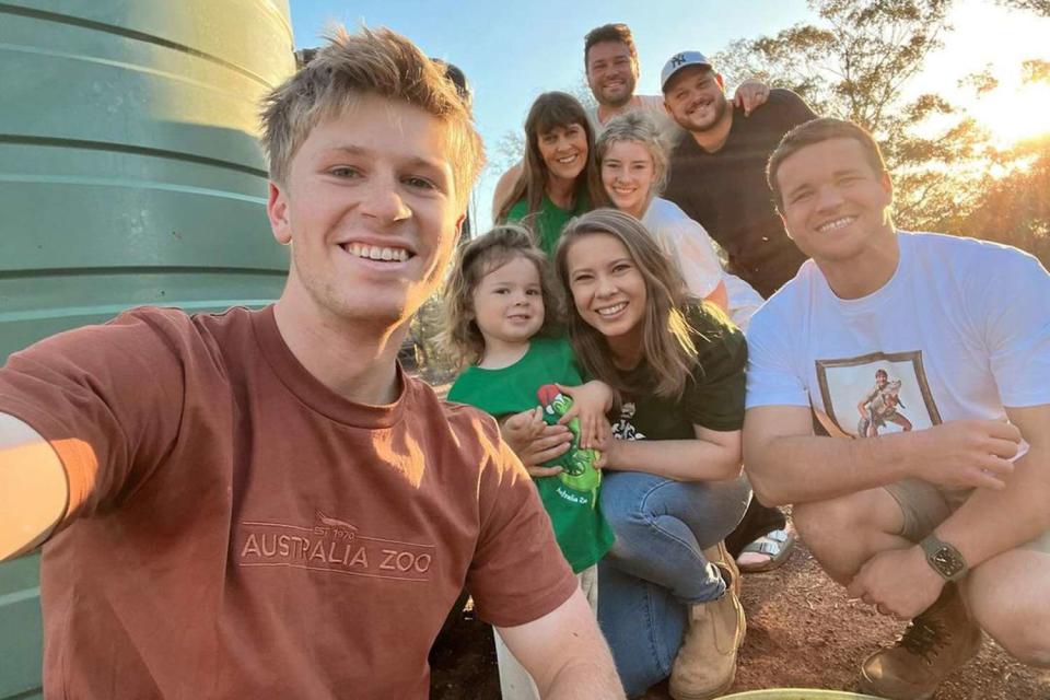 <p>bindisueirwin/Instagram</p> Bindi Irwin shares a family selfie with husband, Chandler Powell, daughter, Grace, mom, Terri, brother, Robert, and his girlfriend, Rorie, on Instagram