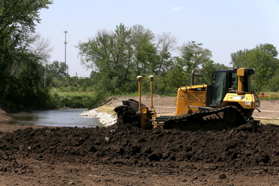 Workers continue the Clear Creek restoration project Thursday, June 6, 2024 in Coralville, Iowa.