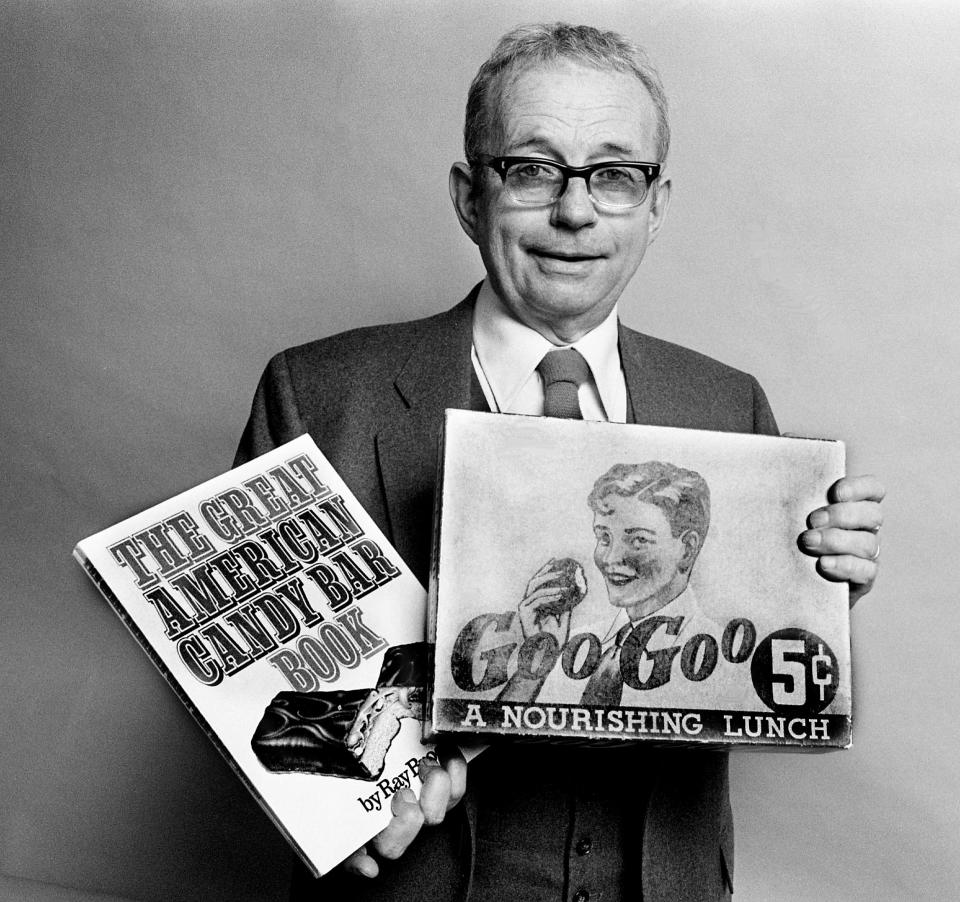 Ray Broekel models his book, “The Great American Candy Bar Book” March 20, 1983, while holding a Goo Goo Cluster box from the 1930s. After consuming over 1,000 candy bars in 1981, the Goo Goo is the author’s favorite candy bar. The author was in Nashville to promote the book and to help publicize the National Confectioners Association’s 100th anniversary.