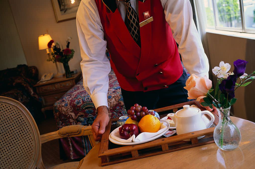 The bellhop brings breakfast on a tray to a room at the Summit Hotel