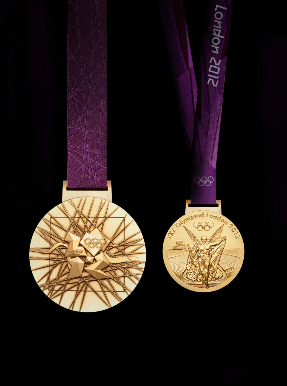 A handout image obtained from the London 2012 organising committee (LOCOG) on July 27, 2011 shows the London 2012 Olympic medals designed by British artist David Watkins. The Olympic medals’ circular form is a metaphor for the world. The front of the medal always depicts the same imagery at the summer Games, the Greek Goddess of Victory, Nike, stepping out of the depiction of the Parthenon to arrive in the host city. The design for the reverse of the London 2012 Olympic medals contains five main symbolic elements: the dished background suggests a bowl similar to the design of an amphitheatre, the core emblem is an architectural expression, a metaphor for the modern City, the grid brings both a pulling together and sense of outreach on the design - an image of radiating energy that represents the athletes’ achievements and effort, the River Thames is a symbol for London and the square is the final balancing motif of the design, opposing the overall circularity of the design and emphasising its focus on the centre and reinforcing the sense of ‘place’ as in a map inset. AFP PHOTO / LOCOG/ HO

ATTENTION - EMBARGO, RELEASABLE Wednesday July 27, 2011 at 1830 GMT - THIS RESTRICTION APPLIES TO ALL MEDIA INCLUDING WEBSITES 
 ---- EDITORS NOTE ---- RESTRICTED TO EDITORIAL USE - MANDATORY CREDIT *AFP PHOTO / LOCOG/ HO* - NO MARKETING NO ADVERTISING CAMPAIGNS - DISTRIBUTED AS A SERVICE TO CLIENTS (Photo credit should read HO/AFP/Getty Images)