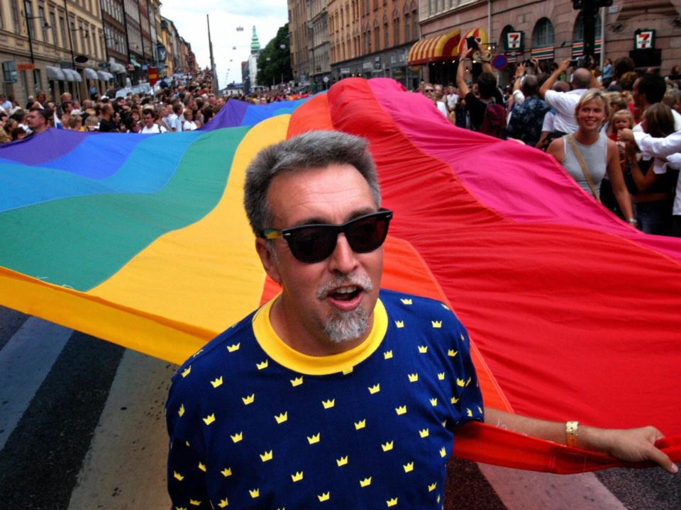 Gilbert Baker heads the Stockholm Pride Parade carrying a 250-metre long flag in Stockholm.