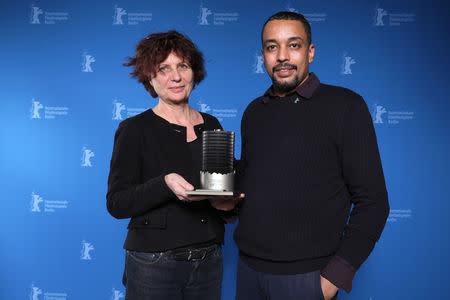 Suhaib Gasmelbari and Marie Balducchi pose with Glashuette Original Dokumentary award for Talking About Trees, after the awards ceremony at the 69th Berlinale International Film Festival in Berlin, Germany, February 16, 2019. Christoph Soeder/Pool via Reuters