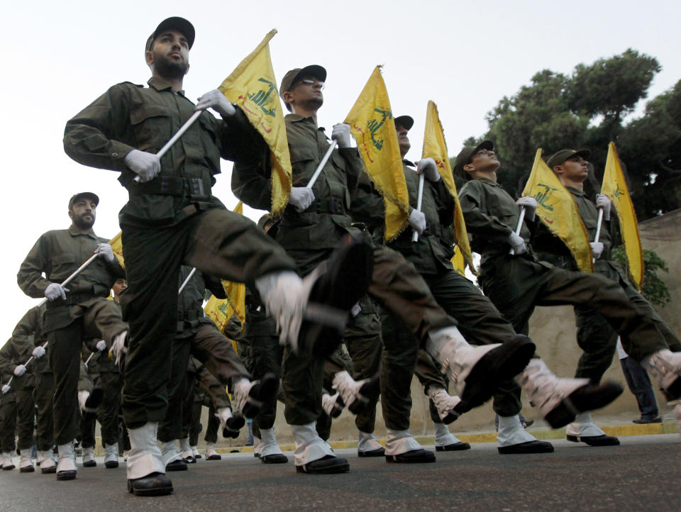 FILE - In this Nov. 12, 2010 file photo, Hezbollah fighters parade during the inauguration of a new cemetery for their fighters who died in fighting against Israel, in a southern suburb of Beirut, Lebanon. From Lebanon and Syria to Iraq, Yemen, and the Gaza Strip, Iran has significantly expanded its footprint over the past decade, finding and developing powerful allies in conflict-ravaged countries across the Middle East. Iran has used groups like the Lebanese Hezbollah to strike its regional foes, and could mobilize them if the latest tensions with the United States lead to an armed conflict, dramatically expanding the battlefield. (AP Photo/Hussein Malla, File)