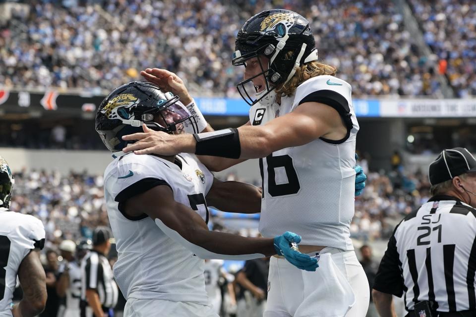 Jacksonville Jaguars wide receiver Zay Jones (7) celebrates after catching a touchdown pass from quarterback Trevor Lawrence, right, during the first half of an NFL football game against the Los Angeles Chargers in Inglewood, Calif., Sunday, Sept. 25, 2022. (AP Photo/Marcio Jose Sanchez)