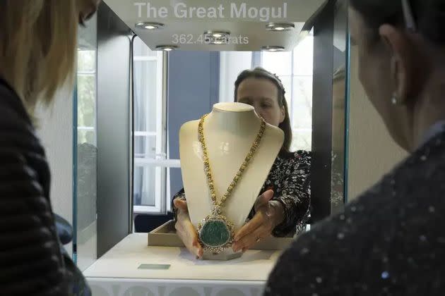An employee of Christie's displays the Great Mogul Emerald and Diamond Necklace by Harry Winston during the preview of 