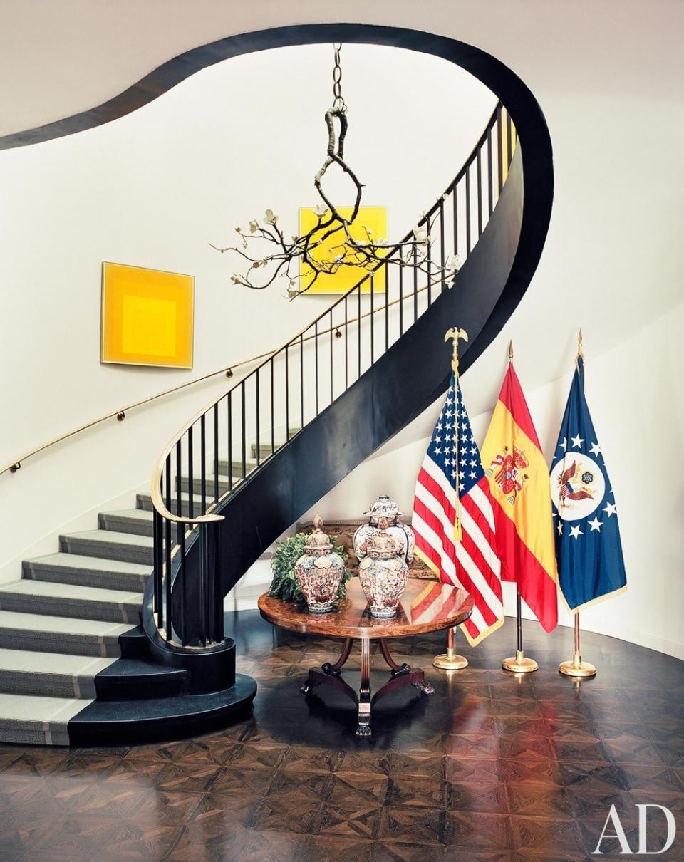 At the U.S. Ambassador to Spain’s <a rel="nofollow noopener" href="https://www.architecturaldigest.com/story/james-costos-michael-smith-designed-madrid-home-article?mbid=synd_yahoo_rss" target="_blank" data-ylk="slk:Madrid residence;elm:context_link;itc:0;sec:content-canvas" class="link ">Madrid residence</a>, most of the art was obtained through the Art in Embassies program, including the David Wiseman light sculpture and Josef Albers paintings that overlook the striking black staircase.