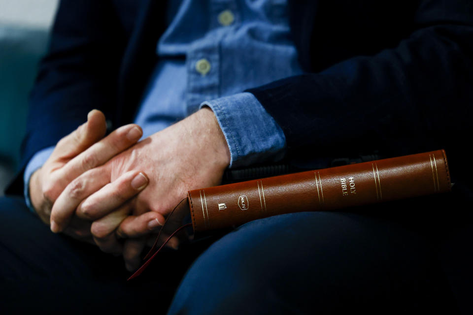 Woodland Park resident Drew DePatie holds a Bible after speaking against “woke” agendas during the public comment period of the Woodland Park School District Board of Education meeting on April 12, 2023 in Woodland Park, Colo. (Michael Ciaglo for NBC News)