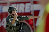 <p>A law enforcement officer directs traffic outside the school following a shooting at Marjory Stoneman Douglas High School in Parkland, Fla., on Feb. 14, 2018. (Photo: John McCall/South Florida Sun-Sentinel via AP) </p>