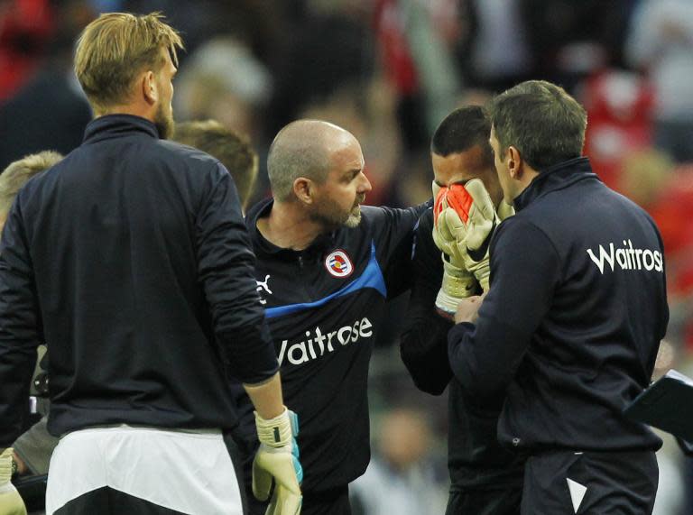 Reading manager Steve Clark (C) comforts goalkeeper Adam Federici after his side lost 2-1 in their FA Cup semi-final against Arsenal at Wembley stadium on April 18, 2015