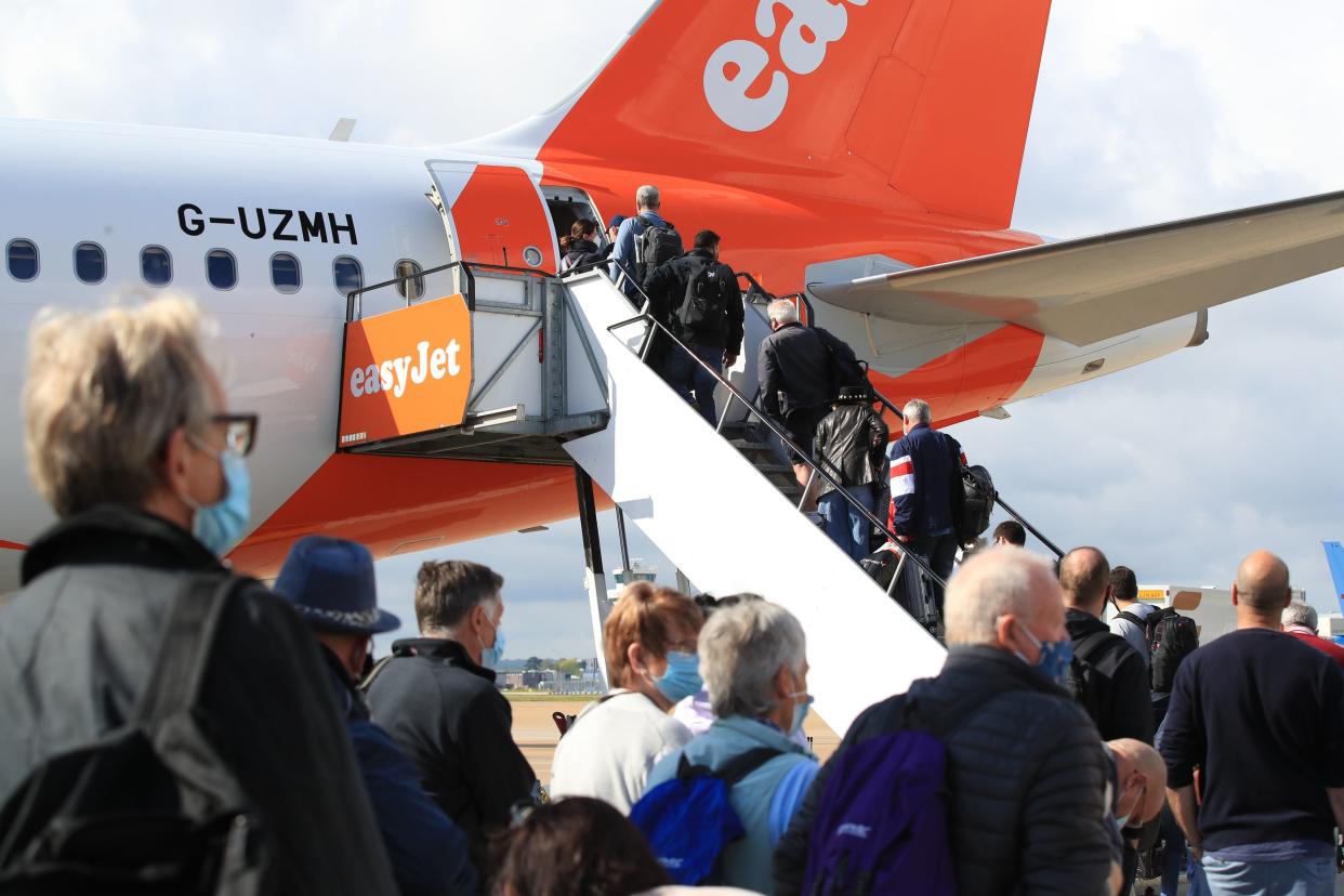 <p>Passengers at Gatwick prepare to board an easyJet flight to Faro, Portugal, on Monday</p> (PA)