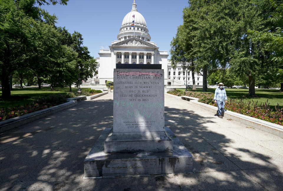 A pedestal where the statue of famed abolitionist Col. Hans Christian Heg stood sits empty outside the State Capitol, Wednesday, June, 24, 2020, in Madison, Wis. Protesters tore down statues of Forward and a Union Civil War colonel. They also assaulted a state senator and damaged the Capitol, Tuesday night after the arrest of a Black activist earlier in the day. (Steve Apps/Wisconsin State Journal via AP)