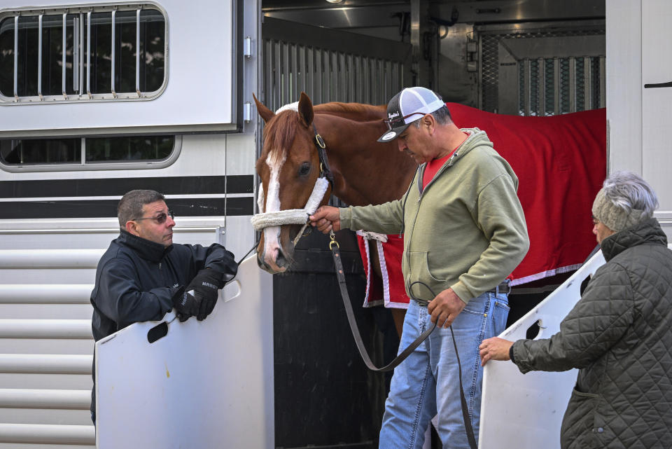 Kentucky Derby winner Mage arrives at Pimlico Race Course early Sunday, May 14, 2023 to prepare for this weekend's Preakness Stakes as trainer Gustavo Delgado, Sr., right, looks on. (Jerry Jackson/The Baltimore Sun via AP)