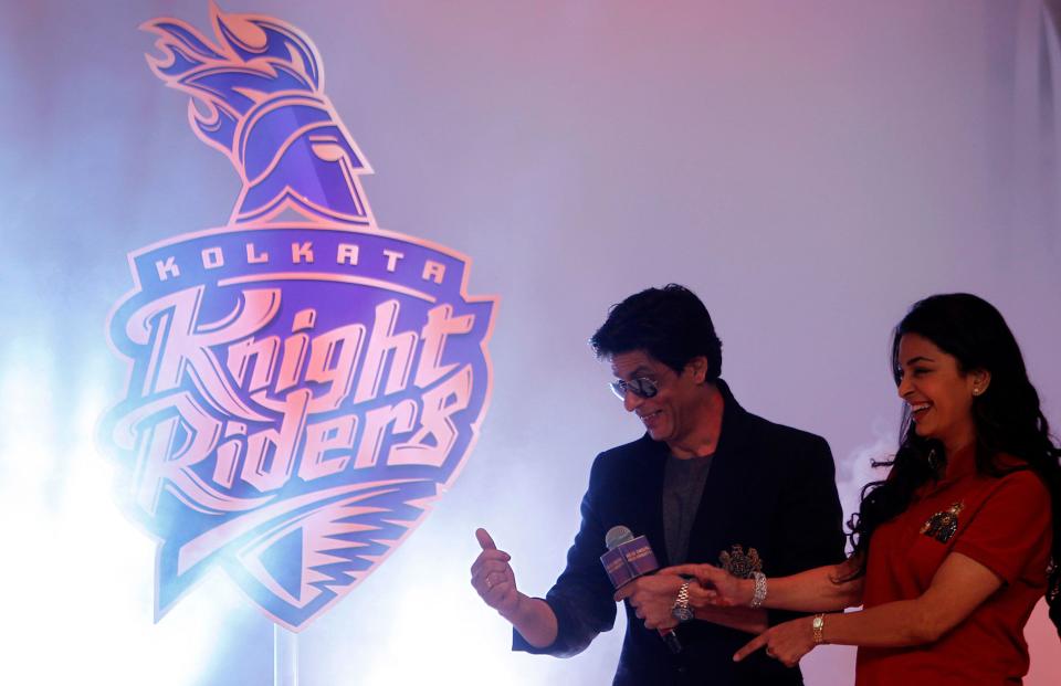 Bollywood actor Shahrukh Khan, second right, and actress Juhi Chawla stand next to the new logo of Indian Premier League cricket team Kolkata Knight Riders (KKR) during the launch of a new marketing campaign of the team in Mumbai, India, Monday, Feb. 13, 2012. (AP Photo/Rafiq Maqbool)