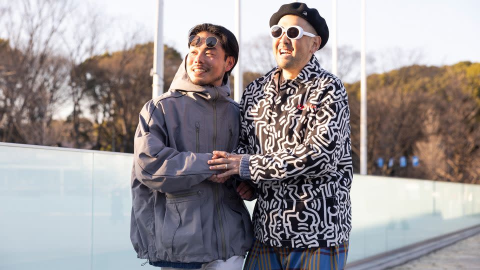 Two guests in jackets and sunglasses. - Matt Jelonek/Getty Images