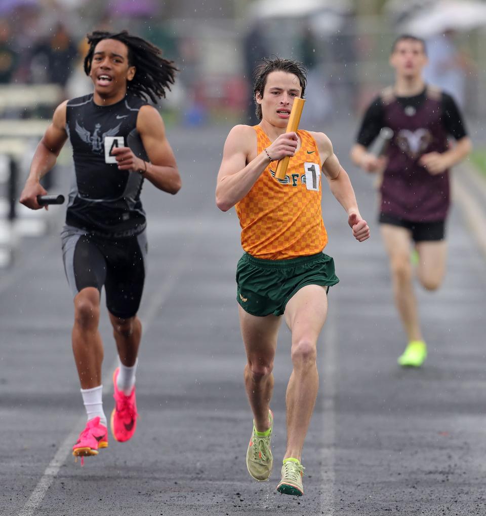 Nate Julien of Firestone, center, leads the group down the final 100 meters of the boys 3,200-meter relay during the City Series track meet at Ellet High School on Saturday, May 13.