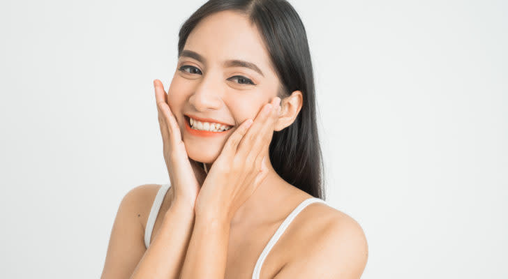 woman smiling with white background representing BFRI Stock.